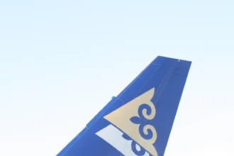 Blue Air Astana A320 tail with its gold emblem at Almaty, photographed in October 2009.