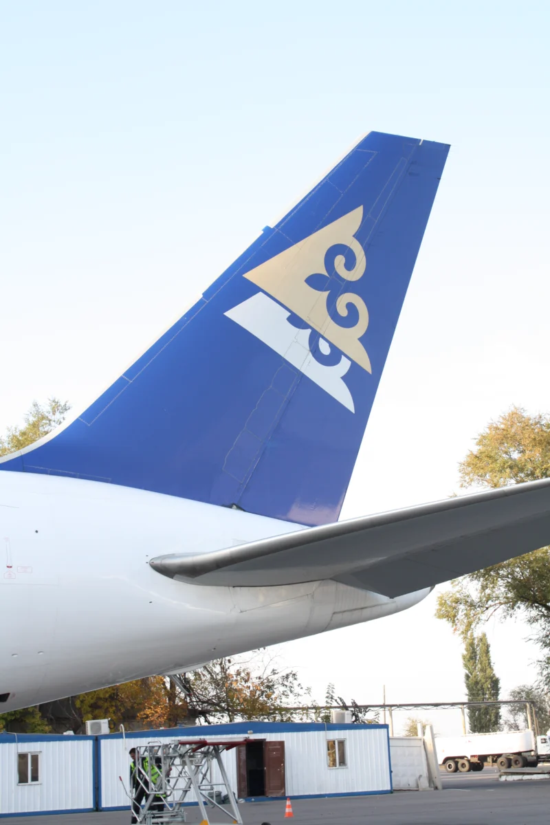 Blue Air Astana A320 tail with its gold emblem at Almaty, photographed in October 2009.