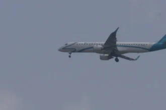 Archive Air Dolomiti Embraer 195 in flight with landing gear extended, photographed June 14, 2015.
