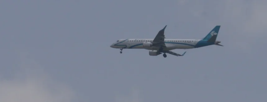 Archive Air Dolomiti Embraer 195 in flight with landing gear extended, photographed June 14, 2015.
