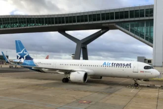 Archive photograph of Air Transat Airbus A321neo C-GOIW parked beneath a terminal bridge at London Gatwick in December 2023.