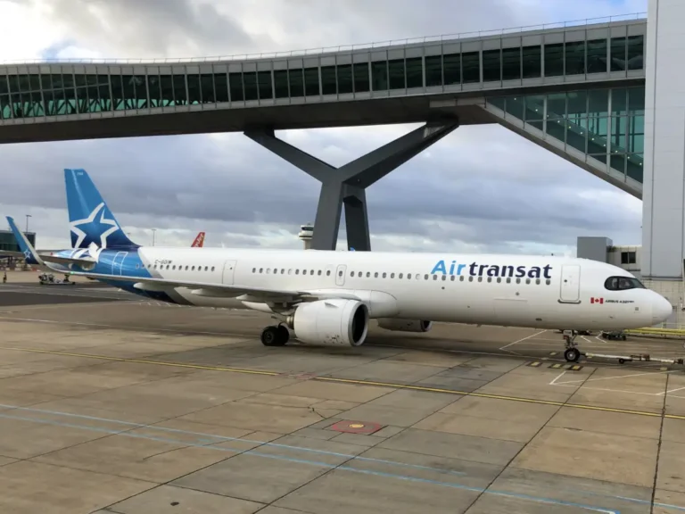 Archive photograph of Air Transat Airbus A321neo C-GOIW parked beneath a terminal bridge at London Gatwick in December 2023.