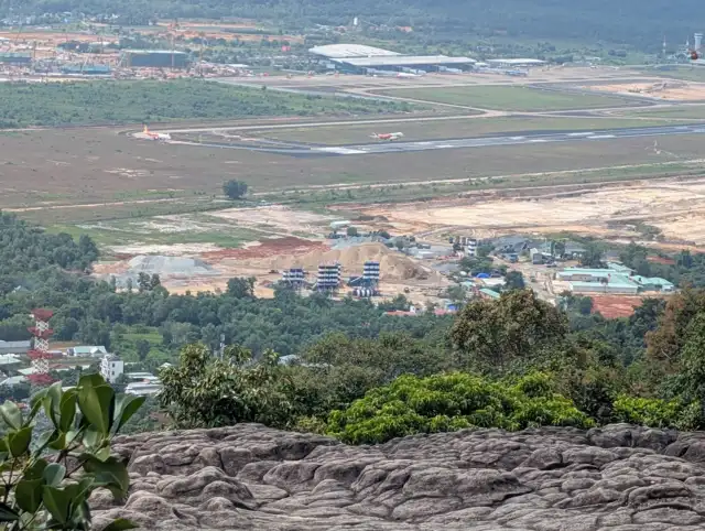 Phu Quoc International Airport viewed from a rocky overlook