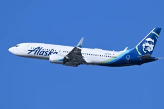 Archive Alaska Airlines Boeing 737 MAX 8 N813AK climbing after departure from Boston in July 2026.
