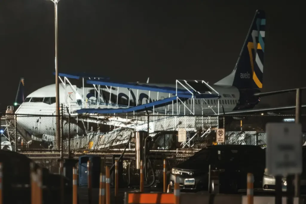 Avelo Boeing 737 parked at Tweed New Haven at night in March 2024, archive photograph