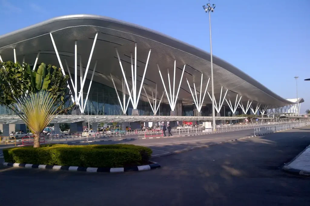 Archive view of Bengaluru airport terminal exterior with white branching columns.