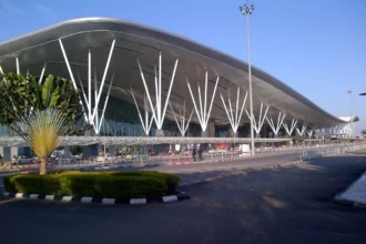 Archive view of Bengaluru airport terminal exterior with white branching columns.