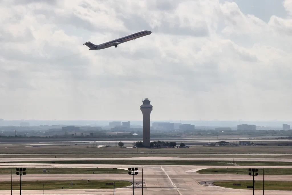DFW control tower and airfield with an American Airlines aircraft departing, photographed in 2012