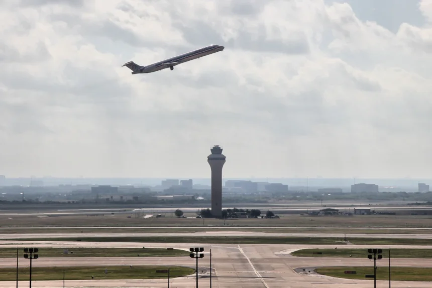 DFW control tower and airfield with an American Airlines aircraft departing, photographed in 2012