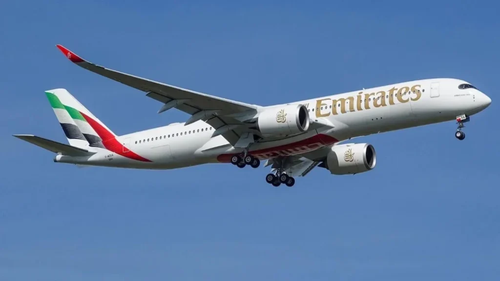 Emirates Airbus A350 in flight with landing gear extended, wearing test registration F-WZGA