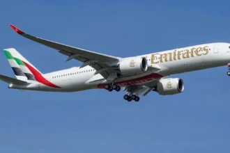 Emirates Airbus A350 in flight with landing gear extended, wearing test registration F-WZGA