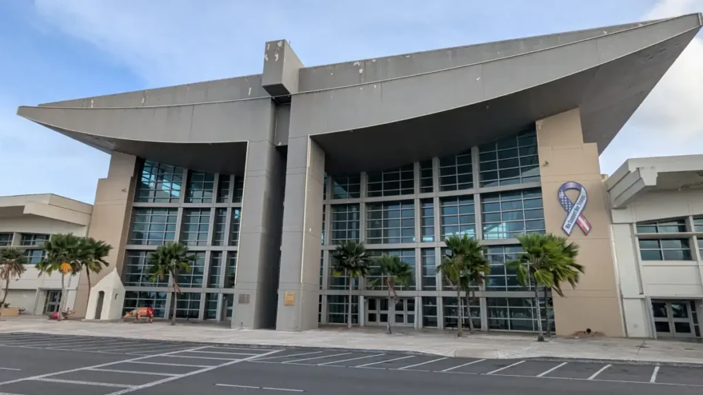 Exterior of Guam airport terminal with palm trees