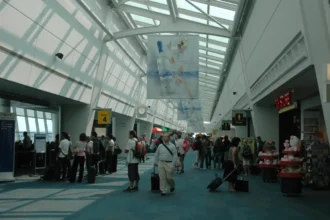 Archive photograph of passengers and boarding gates inside JFK Airport Terminal 1, August 2007.