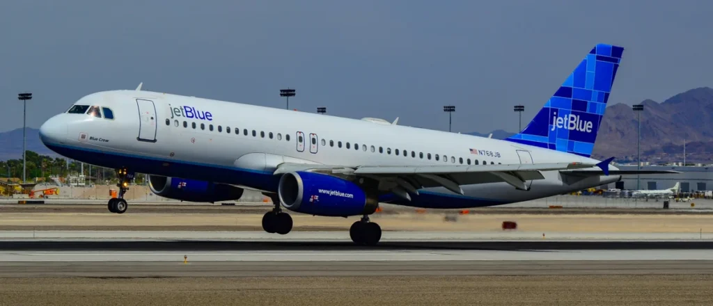 JetBlue Airbus A320 N768JB Blue Crew over a Las Vegas runway in April 2012