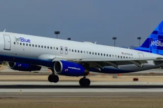 JetBlue Airbus A320 N768JB Blue Crew over a Las Vegas runway in April 2012