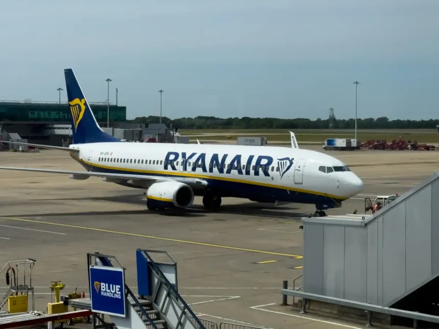 Ryanair Boeing 737 parked beside terminal boarding equipment at London Stansted Airport