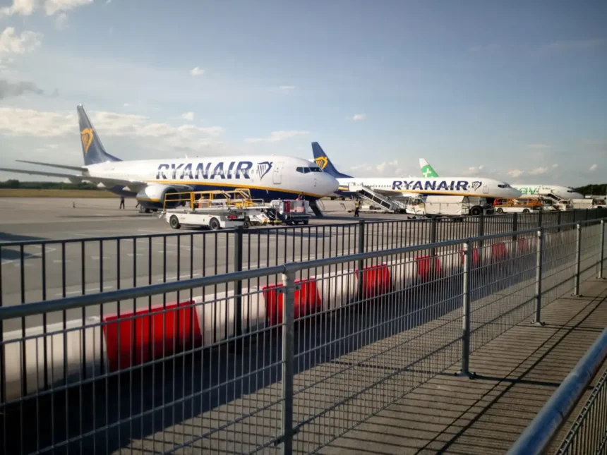 Ryanair aircraft parked at Eindhoven Airport behind an apron fence, June 2019.