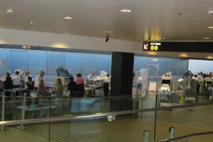 Passengers and security staff at a SEA Airport checkpoint in a 2008 archive photograph