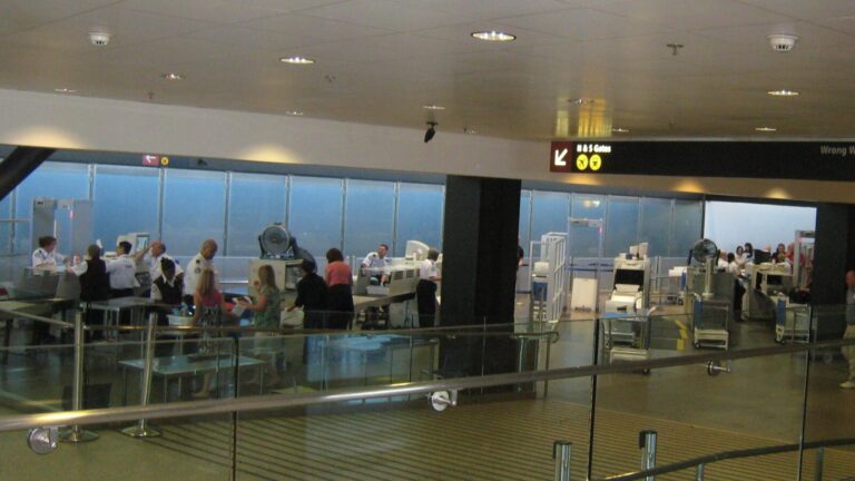 Passengers and security staff at a SEA Airport checkpoint in a 2008 archive photograph