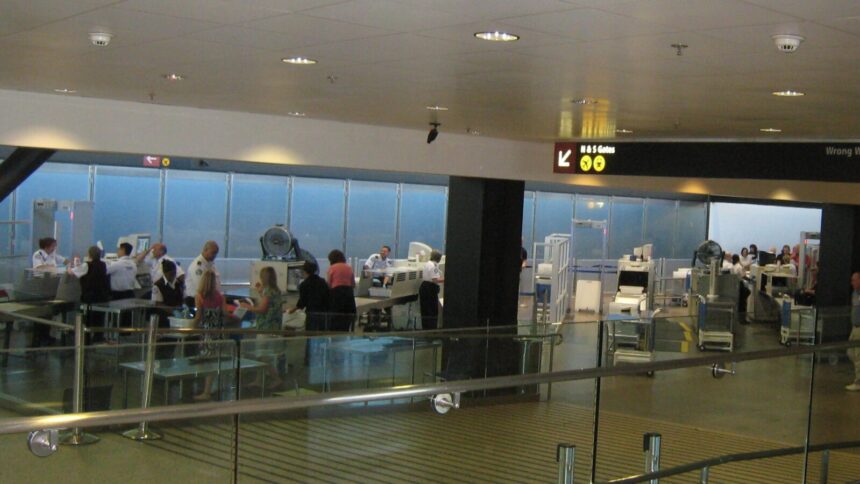 Passengers and security staff at a SEA Airport checkpoint in a 2008 archive photograph