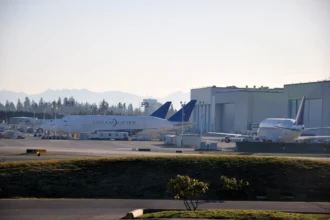 Boeing Dreamlifter cargo aircraft beside factory buildings at Everett in February 2010.