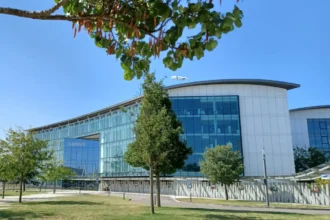 Airbus headquarters at Toulouse-Blagnac with a Beluga aircraft overhead, photographed in August 2024