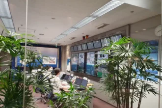 Archive interior at Haneda Airport with staff seated before operational display screens, August 2021.