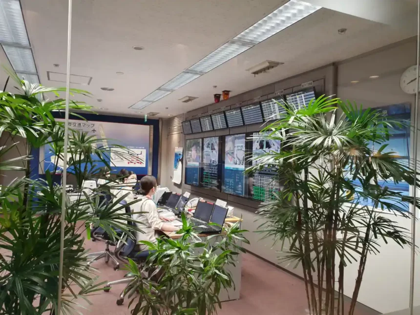 Archive interior at Haneda Airport with staff seated before operational display screens, August 2021.